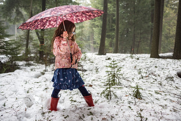 Girl Plays in Northwoods Forest During First Spring Rain