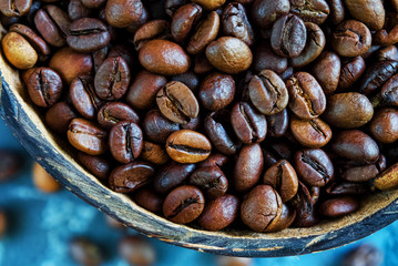 coffee beans in coconut plates. Close-up. Top view