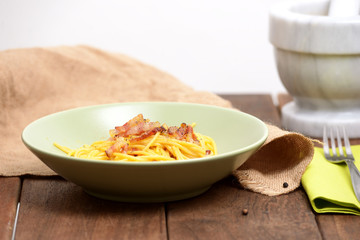 traditional italian dish,  spaghetti carbonara with bacon, egg, aged parmesan
