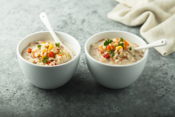 Homemade chowder soup in white bowls