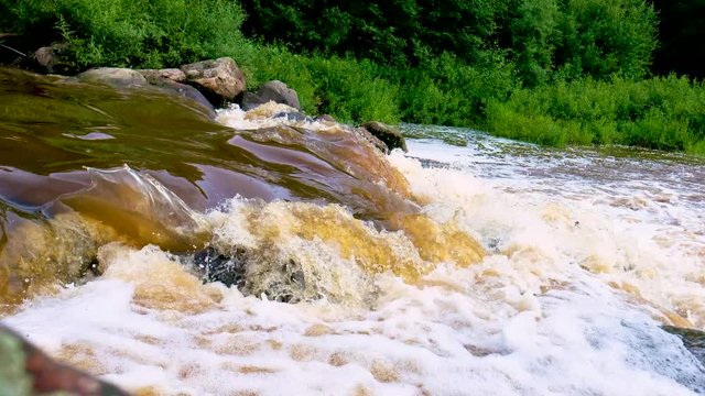 Cascade of the mountain river. Water flowing through rock in river during hike of the valley of desolation.