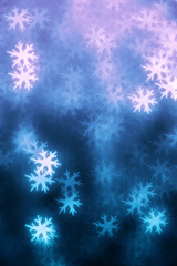 Fototapeta na wymiar Abstract background. Defocused lights in the shape of snowflakes