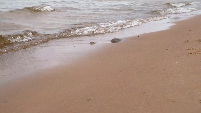Closeup Of Sea Waves Washing Ashore A Sandy Beach Soft wave of the sea on the sandy beach