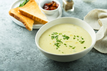 Homemade creamy asparagus soup in a white bowl
