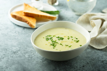 Homemade creamy asparagus soup in a white bowl