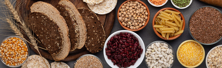 Various grains, beans, nut and bread on wooden background