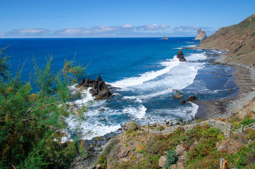 Naklejka premium Playa Benijo, wild nudist beach with big waves and black volcanic sand, located on the north of Tenerife near the Roques de Anaga.