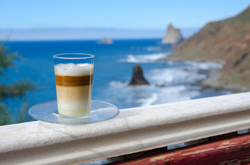 Barraquito, typical a multi-layered coffee liqueur drink on terrace with a view of Benijo beach in Tenerife Island, Spain.
