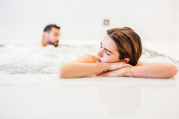 Man and woman enjoying the whirlpool in a spa