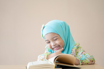Muslim kid reading the book in the class. Education concept