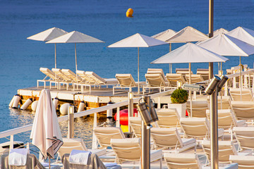 Sea bay with yachts boats and beach umbrella in Cannes