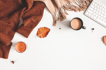 Autumn composition. Cup of coffee, sweater, plaid, autumn leaves on white background. Flat lay, top...