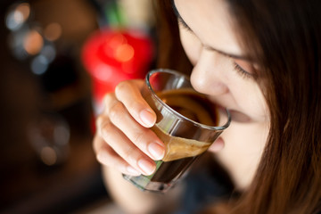 Beautiful asian woman is drinking coffee