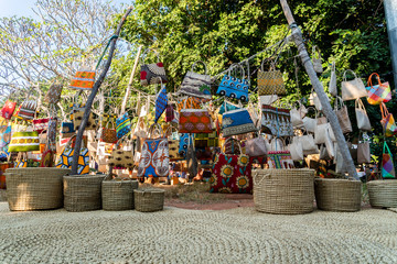 Fototapeta na wymiar Traditional african market selling colorful bags hanged on trees, Maputo, Mozambique