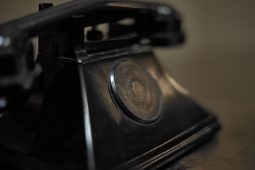 Blurred vintage phone on dark background. Close Up