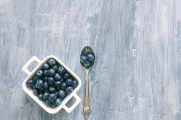 Fresh raw blueberries. Overhead, top view or above view composition with copy space