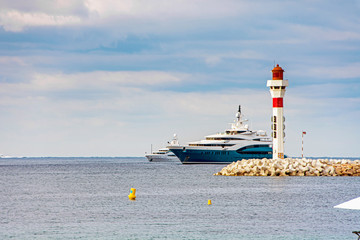 Lighthouse lantern with yachts and boats in Cannes