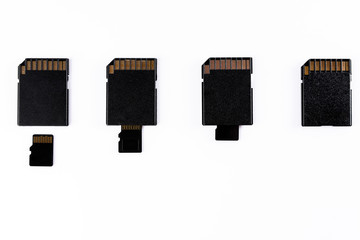 four micro sd entering into four sd cards isolated in white background