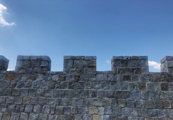 fortified castle wall on background blue sky