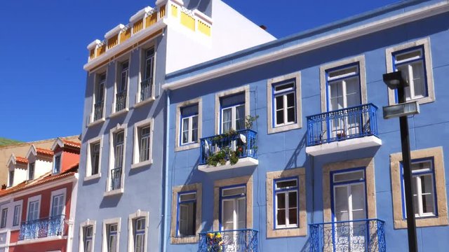 Panning of colourful facade of buildings in Cacilhas, Almada, Portugal on a sunny summer day