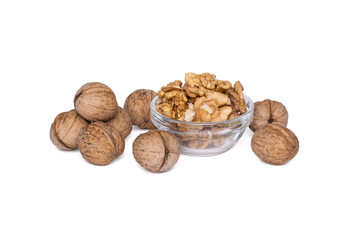 Whole and chopped walnuts in a glass bowl