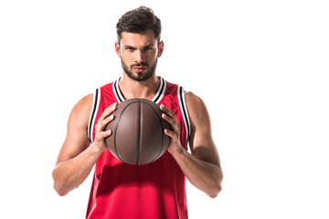 serious athletic basketball player in uniform with ball Isolated On White