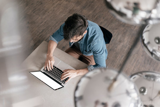 Young Man Working On Laptop, Top View