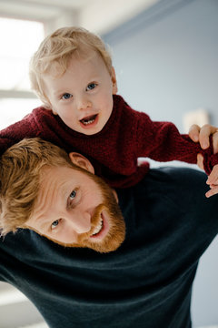 Portrait of father and son playing at home
