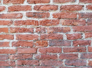 Fragment of an old historic red brick wall as a background or texture