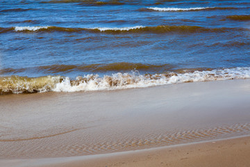 Sea waves wash the sandy shore.