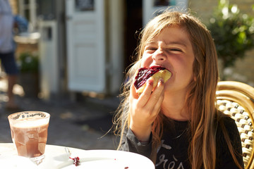 Portrait of girl eating bread with jam