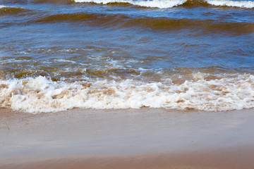 Sea waves wash the sandy shore.