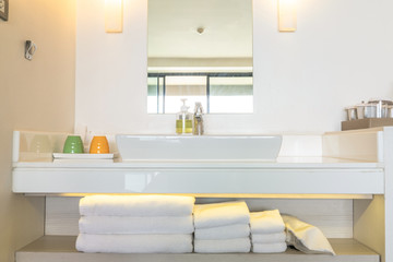 Toiletries are arranged in the shelf under the sink ready for resort client to use.