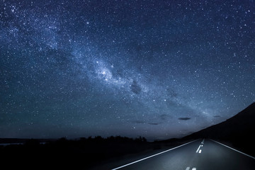 View of empty road against starry sky at night