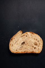 Fresh sliced ​​bread on a black background. View from above