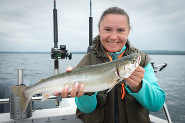Arctic char fishing trophy in female hands