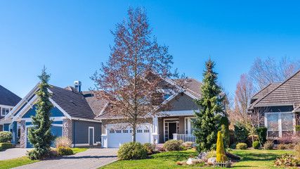A perfect neighbourhood. Houses in suburb at Summer in the north America. Luxury houses with nice landscape.
