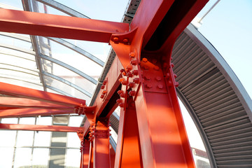 Red iron beams bolted on. Connection of several iron beams in one place.