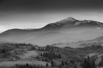 Amazing Carpathian landscape of  misty mountain hills and cloudy sky in black and white. Ukraine.