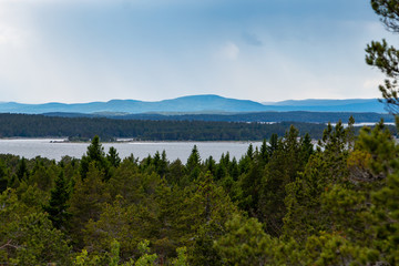 Fototapeta na wymiar Beautiful typical Swedish landscape with lakes and forest and hills 