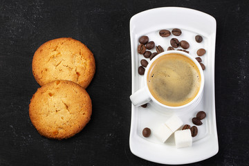 white cup of fresh hot coffee, grains of coffee and sugar cubes