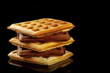 Freshly baked Viennese waffles on a black table