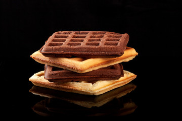 Freshly baked Viennese waffles on a black table