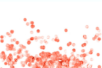 Bright coral confetti isolated on white background.