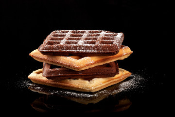 Freshly baked Viennese waffles on a black table