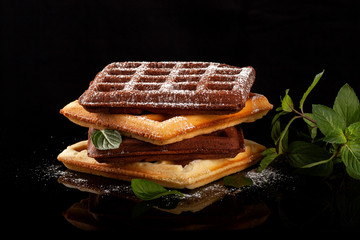 Freshly baked Viennese waffles on a black table