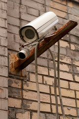 outdoor video cameras on a brick wall background