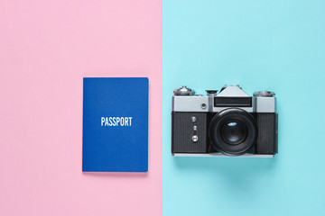 Tourist minimalism concept. Flat lay travel concept. Retro camera and passport on a pastel...