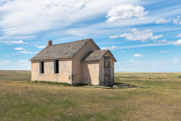 Fototapeta na wymiar Abandoned One Room School on a Hilltop in Cypress County, Alberta, Canada