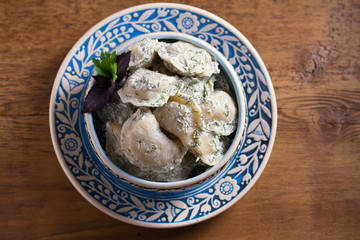 Dumplings stuffed with popato. Pierogi, varenyky, vareniki, pyrohy - dumplings with filling. Healthy vegetarian homemade food. View from above, top studio shot